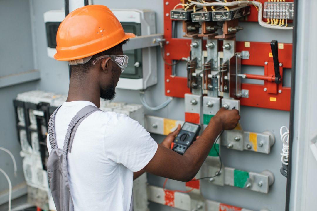 Licensed electrician checking voltage in an electrical panel